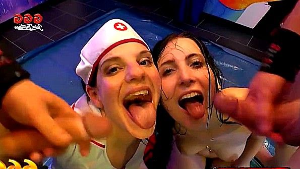 Две девушки сидят на парне. Одна на его сандалии, другая на его человеческом лице